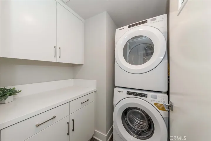 Laundry room is adjacent to the second bathroom. Washer and dryer are included in sale.
