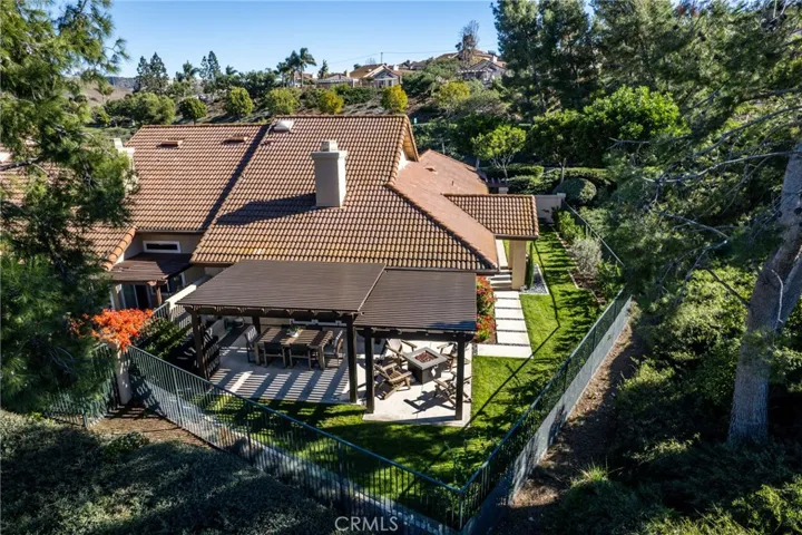 Entertain your guests in the Backyard featuring a covered patio, outdoor grill and dining area, with a large grassy area that wraps around.
