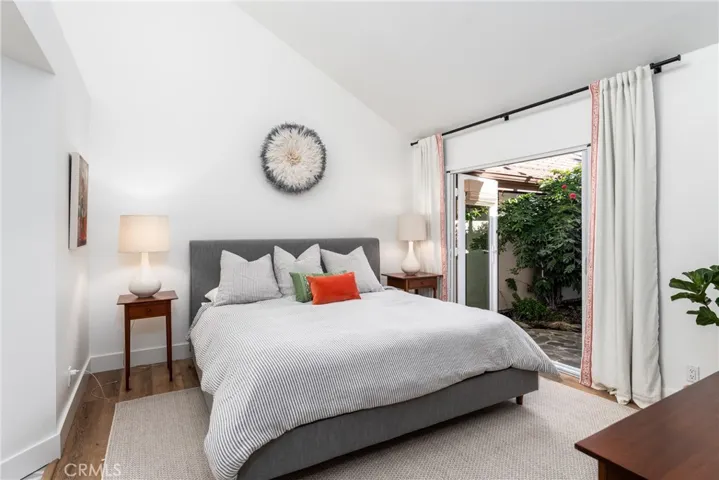 Downstairs Primary Bedroom with soaring ceilings and en suite bathroom. Opens into a lovely private outdoor patio.