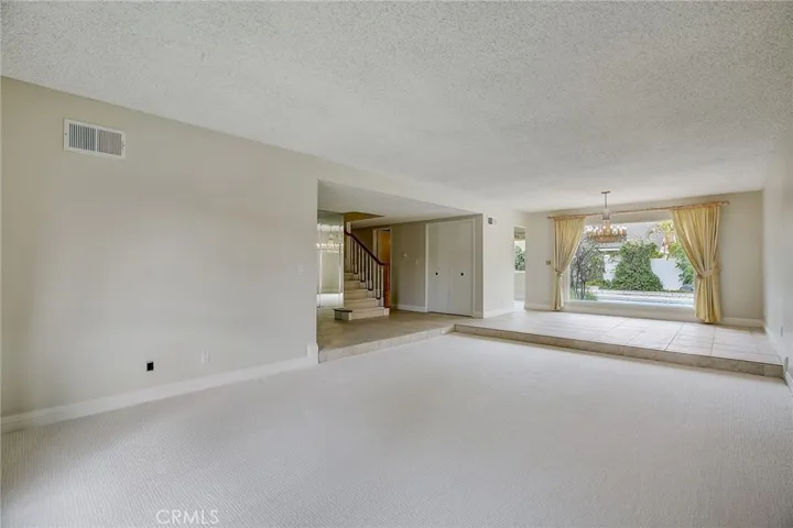 Large Formal Living room connects to elevated dining room