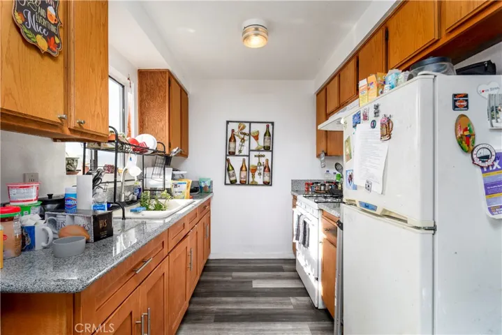 kitchen with granite counters, new floor, gas stove and range.