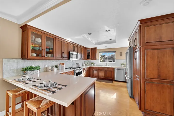 This Chef-Inspired Kitchen has been Expanded and Completely Remodeled. Silestone Quartz Counters, Breakfast Bar, Glass Mosaic Backsplash, Stainless Appliances, Custom Self-Closing Cabinetry, Pantries with Pull-Outs and More!