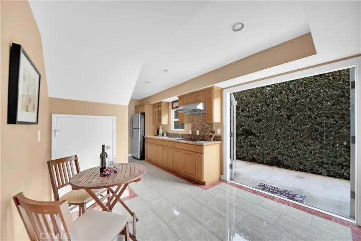 Downstairs Unit Kitchenette with Breakfast Nook and French Doors that Open to Backyard Patio