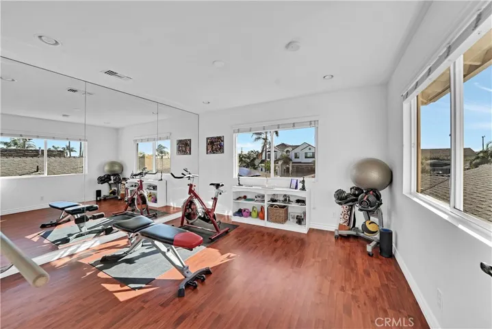 Dance Studio or Gym or Office or 7th Bedroom has Wood Laminate Flooring, Recessed Lighting, Custom Mirrored Wall, Ballet Bar, and Dual Pane Windows