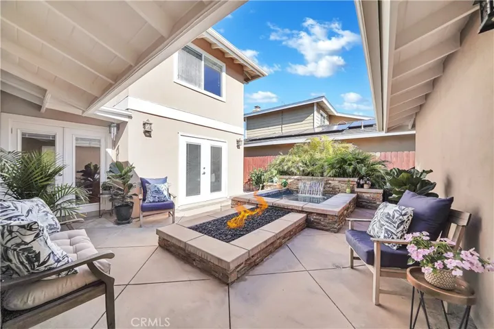 Tropical Paradise Atrium -- Slate Accented Courtyard/Patio with Custom Stacked-Stone Oversized Spa with Waterfall and Large Fire Ring.