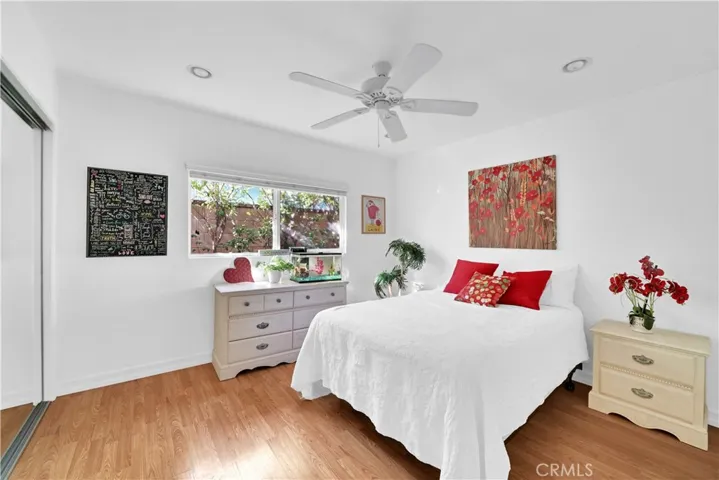 3rd Bedroom in Main House has Mirrored Closet, Wood Laminate Flooring, Ceiling Fan, and Recessed Lighting