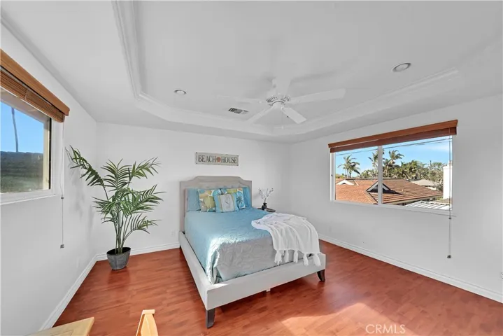 Primary Bedroom in Upstairs Unit has Large Walk-In Closet. Coffered Ceiling, Recessed Lighting, Ceiling Fan, Dual Pane Windows, and Wonderful Ocean Breezes