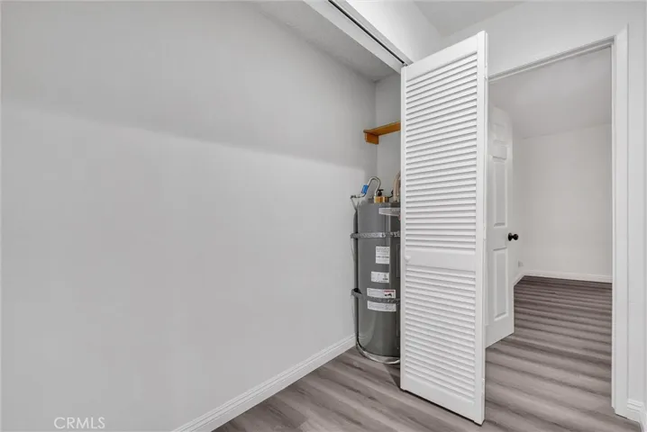 East view of hallway toward guest room and adjacent water heater closet.
