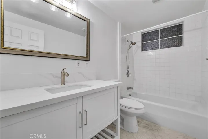 Guest bathroom with new vanity, faucet and toilet.