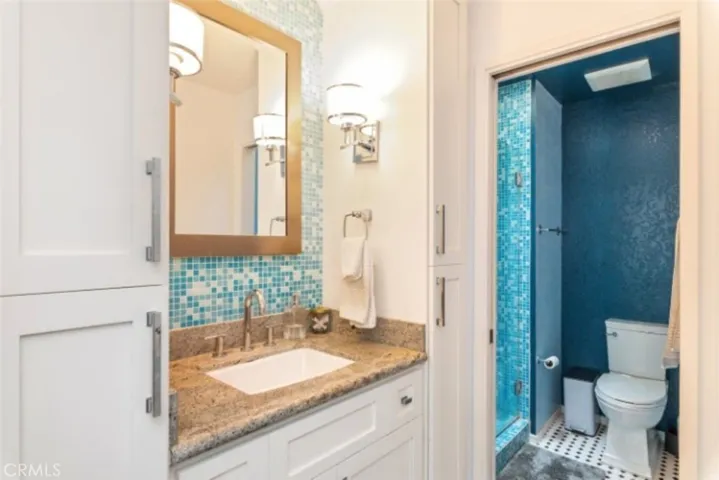 Elegant primary bathroom, with rainfall showers installed and Skylight