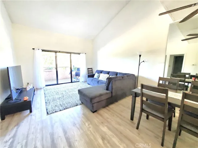 Spacious living room with sliding doors leading to a large balcony