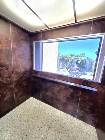 Large community elevator with glass window.