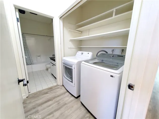 1 year old side by side laundry in hallway closet