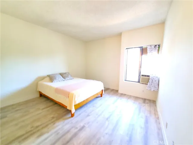 Spacious primary bedroom with window A/C unit