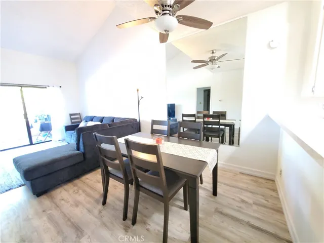 Dining area with vaulted ceiling and ceiling fan