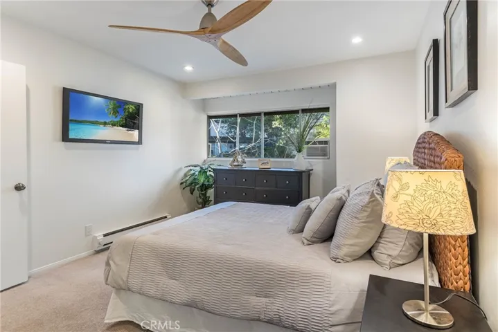 Beautiful 2nd bedroom with great light and large windows to see the park like setting outside.  **please note that TV is for staging purposes only and not currently wired for wall mount.