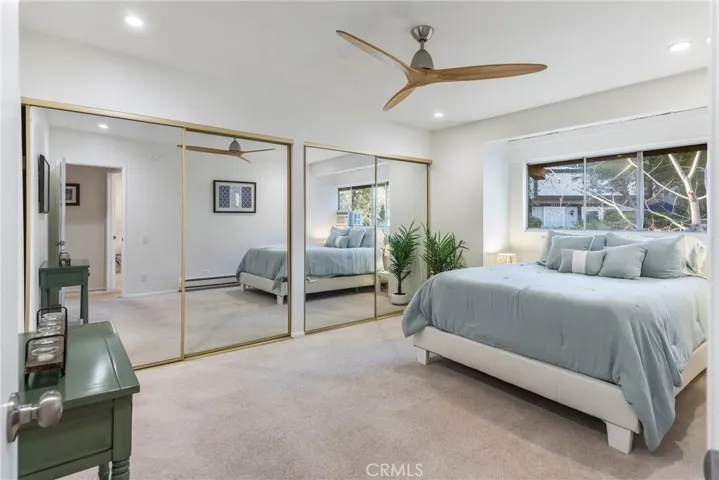 Larger bedroom featuring great light, recessed lights, new paint, ceiling fan, window mounted A/C and huge closets.