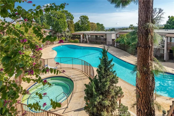 One of three beautiful pool and spa areas throughout the community with ocean views in the distance