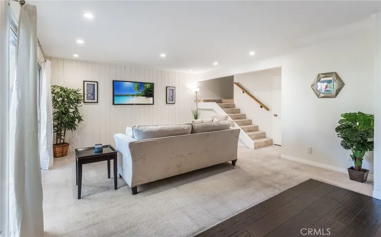 Bright and open with recessed lights, large slider to the patio, hardwood floors in the kitchen and dining rooms.  Please note that TV is a staged TV and not currently wired for wall mount.