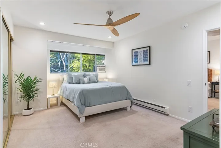 Larger bedroom featuring great light, recessed lights, new paint, ceiling fan, window mounted A/C and huge closets.