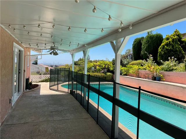 Covered patio and gated pool area