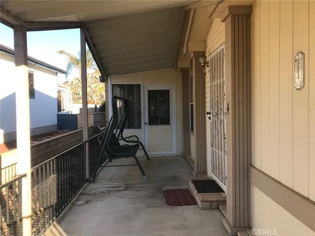 FRONT PORCH TOWARD ENCLOSED PATIO ROOM