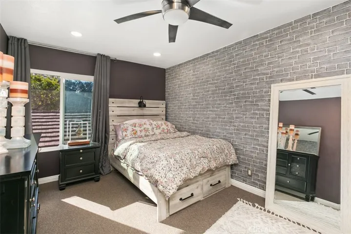 Secondary bedroom with darling brick wallpaper.