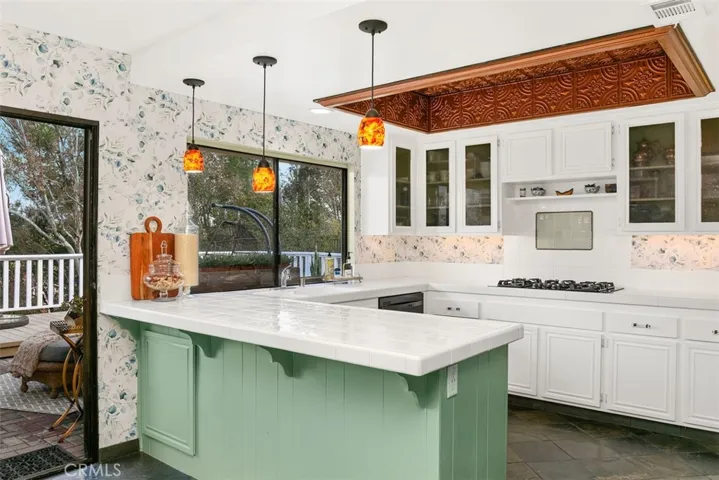 The copper tiles match the copper refrigerator