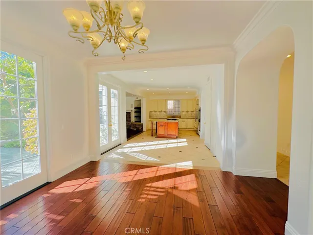 View of kitchen, nook and family room from formal dining room