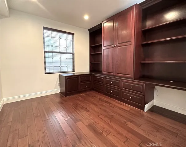 Downstairs bedroom with built in cabinets and desk