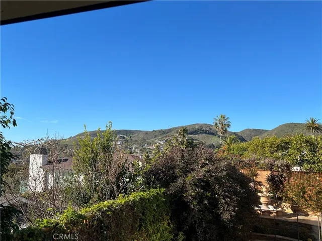 The hills of Laguna Beach are photographed from the front door of the apartment.