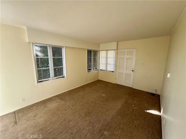 The front door opens into this nicely carpeted living room.