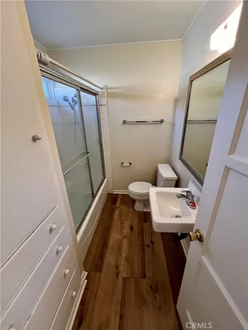 The enclosed tub has an overhead shower.