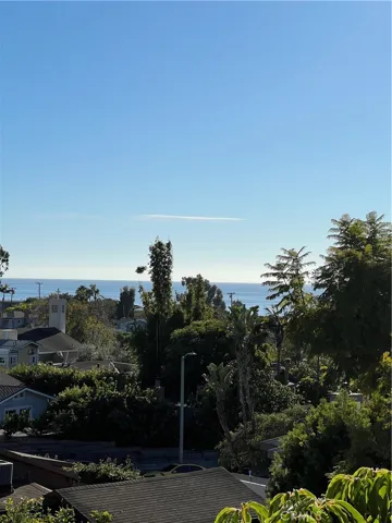 This quiet apartment has a distant ocean view.  The foliage creates a fine setting.