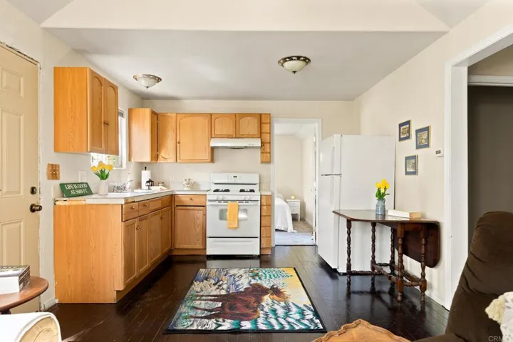 Open and bright kitchen with gas stove, lots of cabinet storage and stainless sink with a disposal