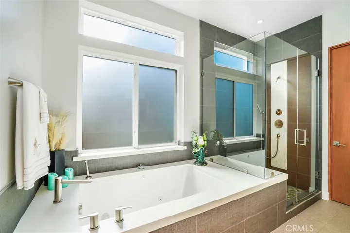 Large tiled shower for a full bath experience.