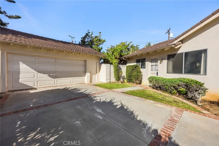 View of the 2 car detached garage and the side entrace off of the driveway. The gate leads to the backyard.