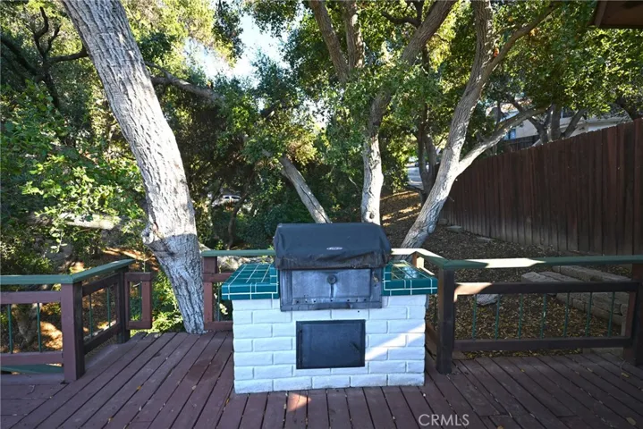 Barbecue on upper deck, with view of private park like grounds.