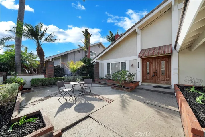 As you step through the gated front courtyard adorned with raised planters, the double door entry invites you into this spacious home boasting 5 bedrooms and 3 bathrooms, with the convenience of one bedroom located downstairs.