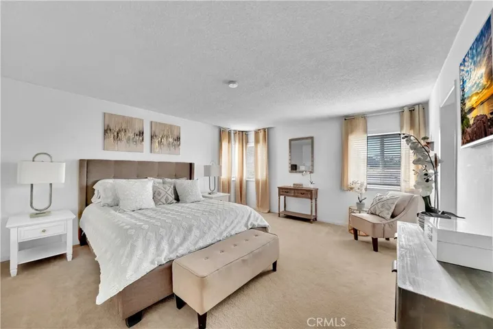 The master bedroom with dual walk-in closets and a private attached bathroom