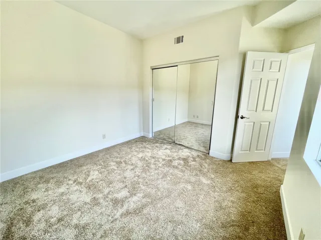 bedroom #2 with new carpet and mirror wardrobe closet doors