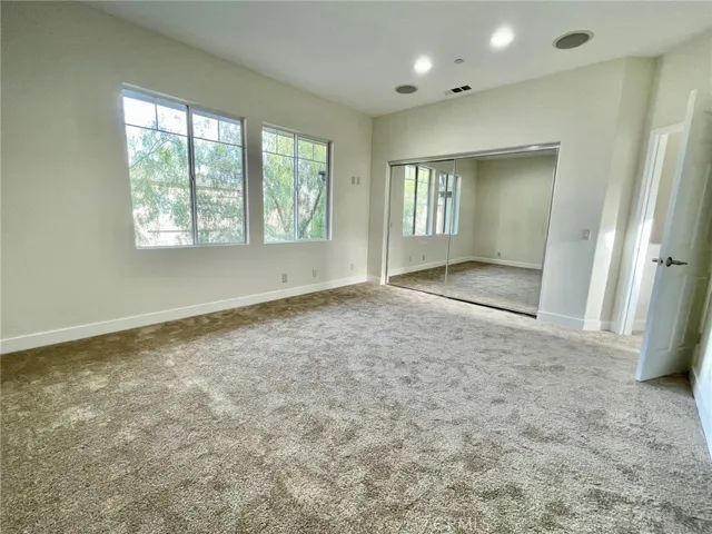 Primary bedroom with new carpet and recessed lights (new wood blinds to come)