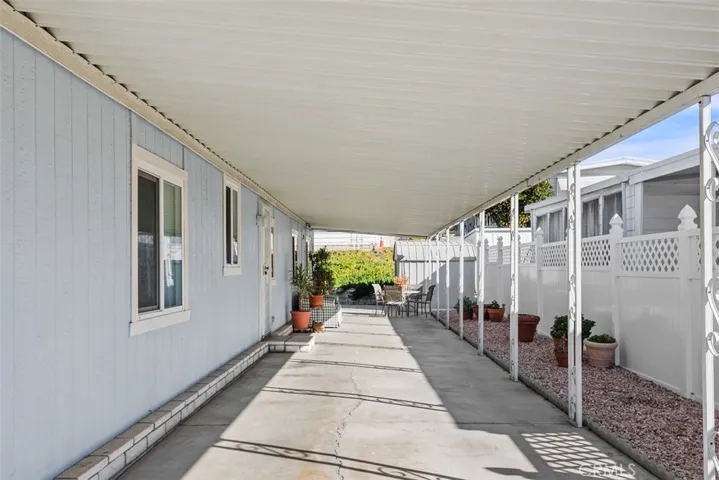 Long covered carport can accommodate 3 cars, I'll bet!