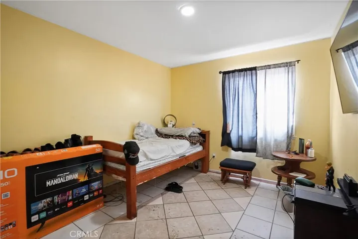 Bedroom 2- large tile flooring and good space closet