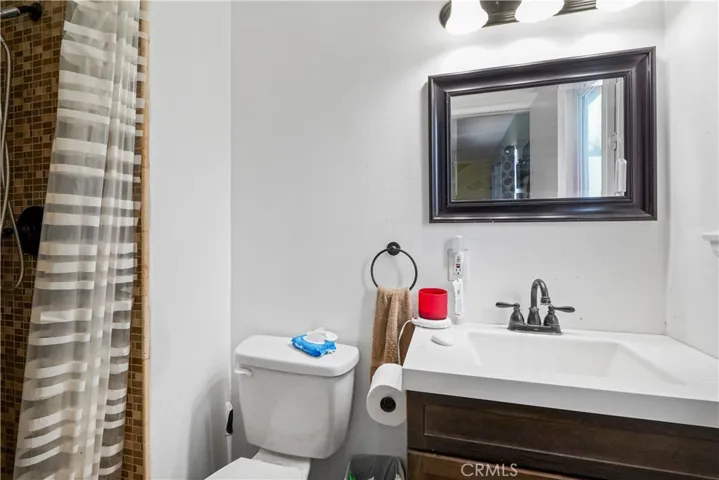 Private Main/Master Bathroom 2- Walk-in shower with stone flooring and decorative Spanish tiled backsplash.