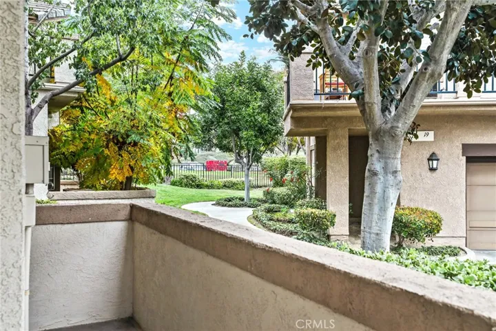 The patio view with park beyond the fence.
