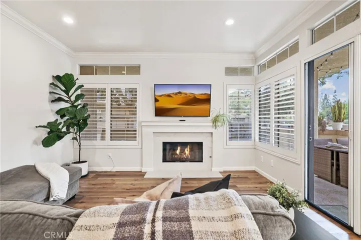 Another view of the sunny living room with french door and phantom screen access to the covered patio on the right.