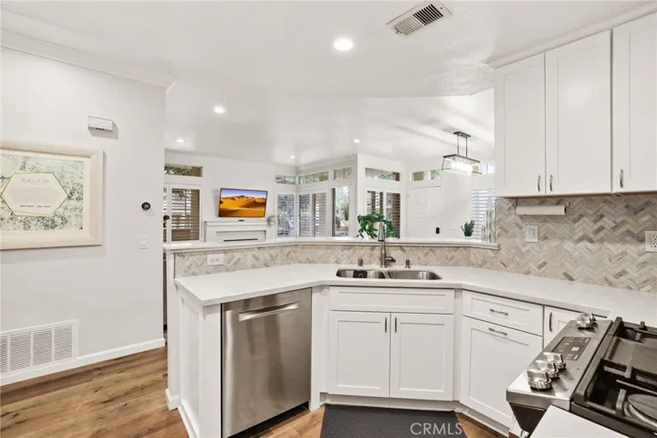 This kitchen also has a stainless steel dishwasher.