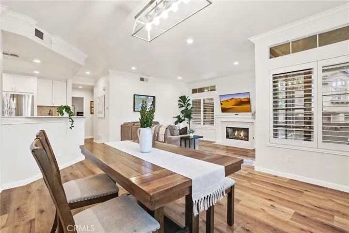 The dining room with kitchen on the left and living room on the right. The window on the right overlooks the covered patio.