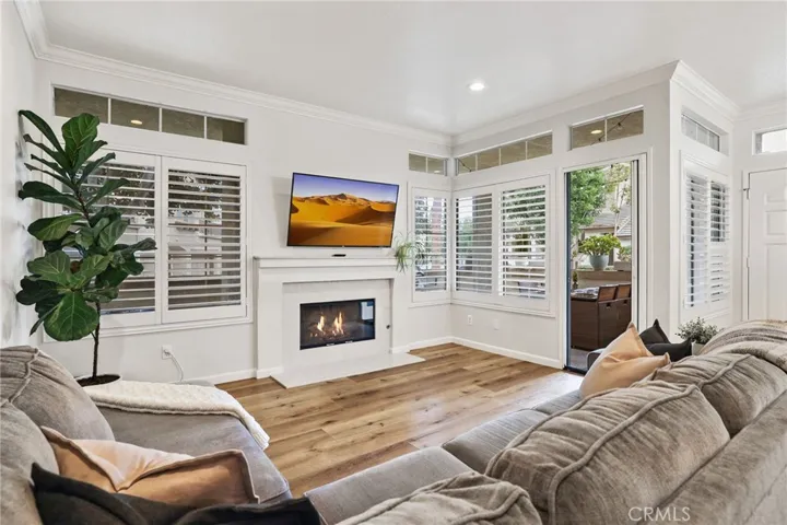 The living room with windows on the right that overlook the lovely wrap around patio.